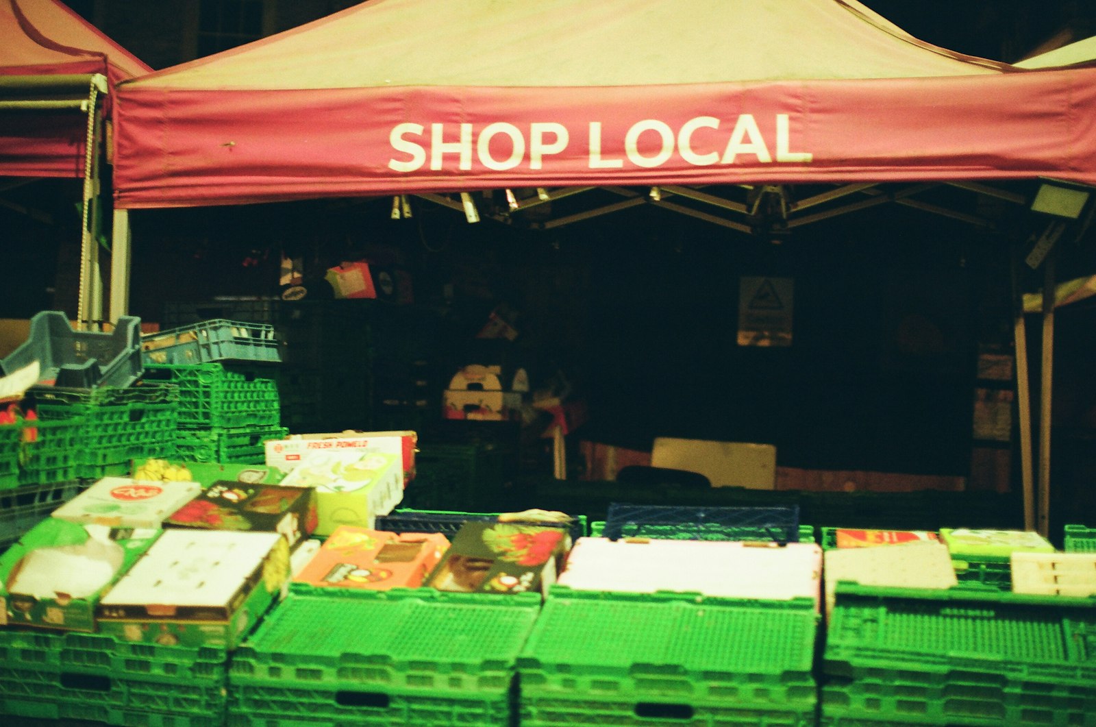 An independent market stall with a 'shop local' banner