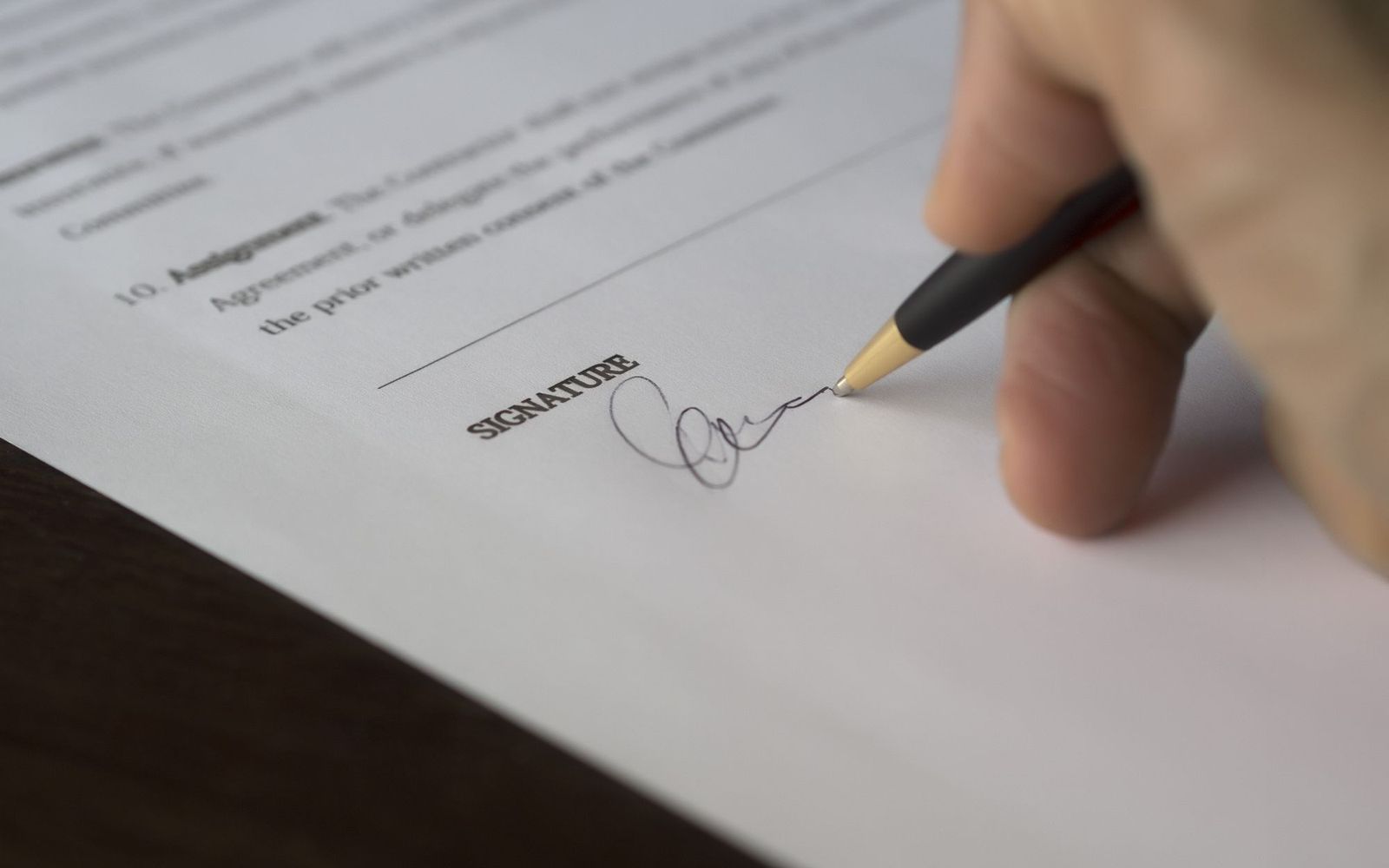 A close-up of someone holding printed paperwork
