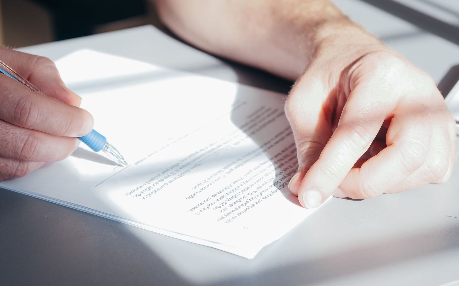 Two people in a small business meeting reviewing notes