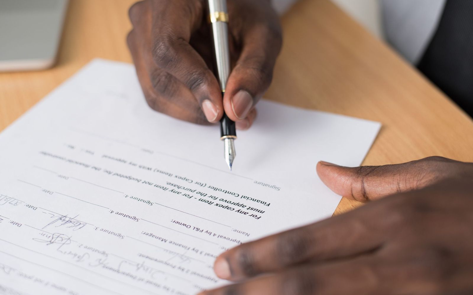 A close-up of someone holding printed paperwork