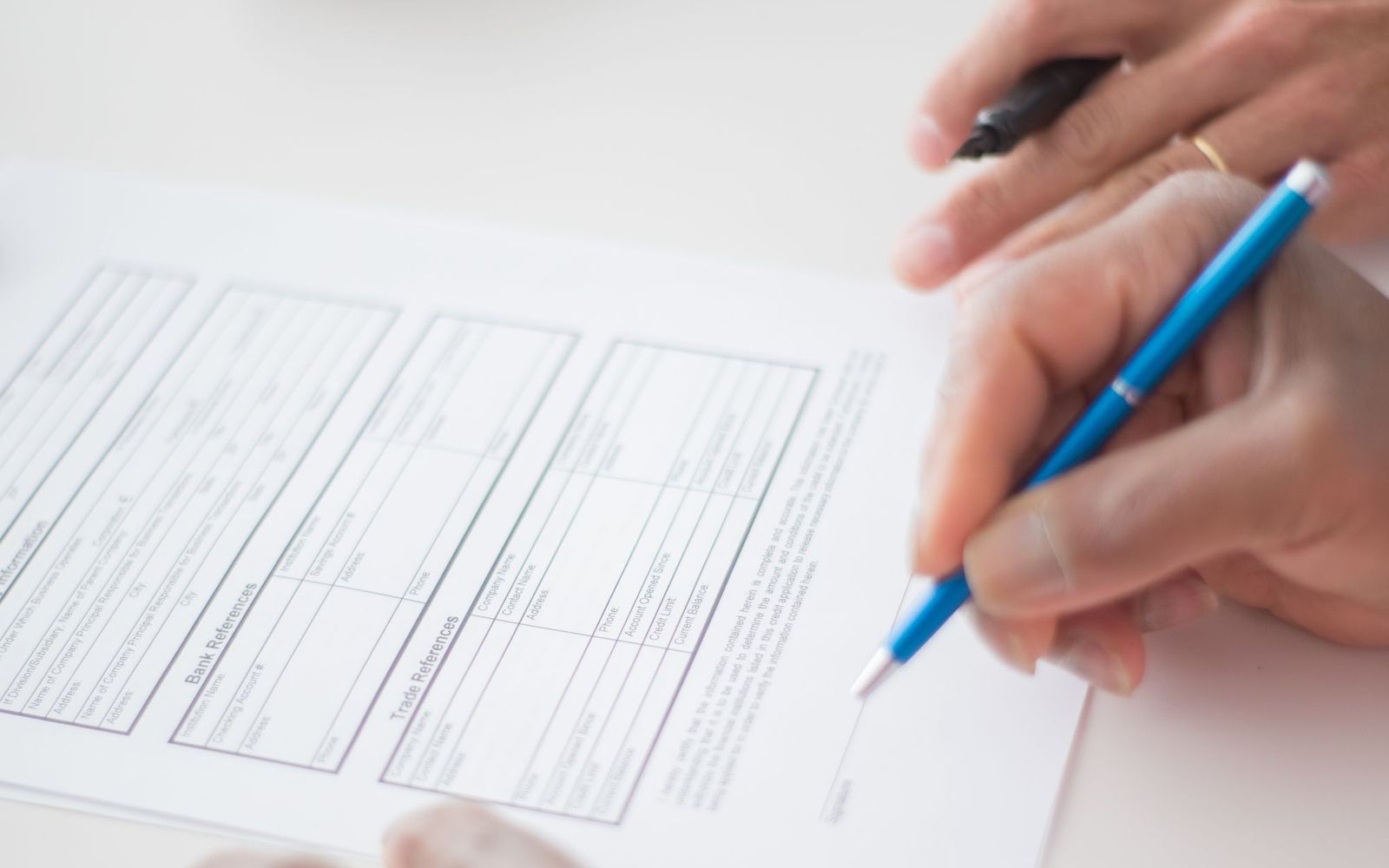 A close-up of someone holding printed paperwork