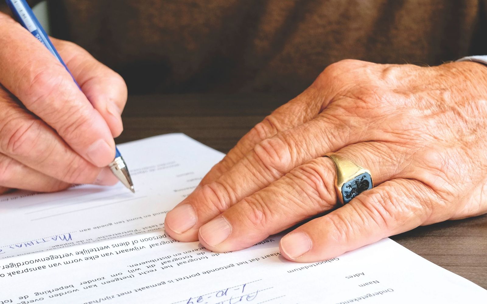 A close-up of someone holding printed paperwork