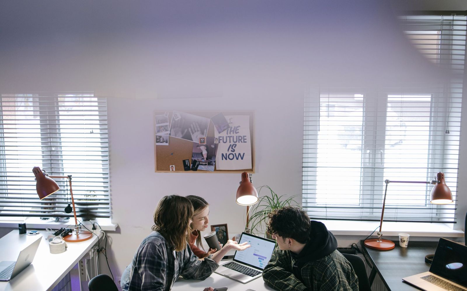 A laptop and coffee on a kitchen table