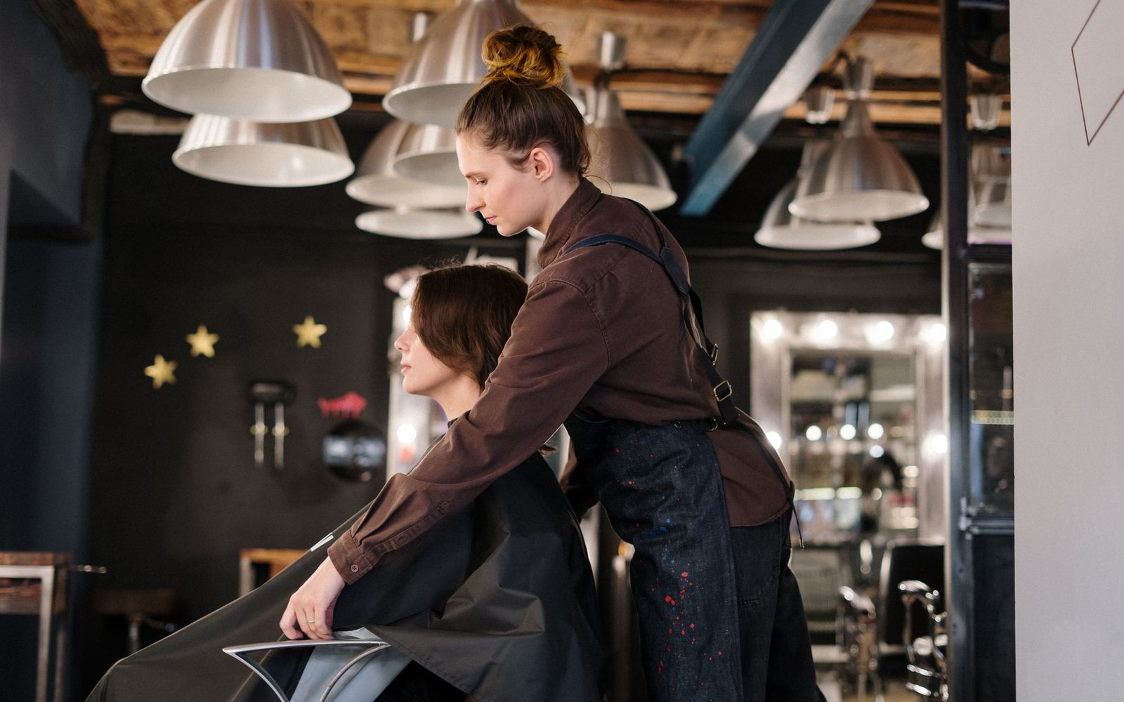 Two people talking across a desk in a small office