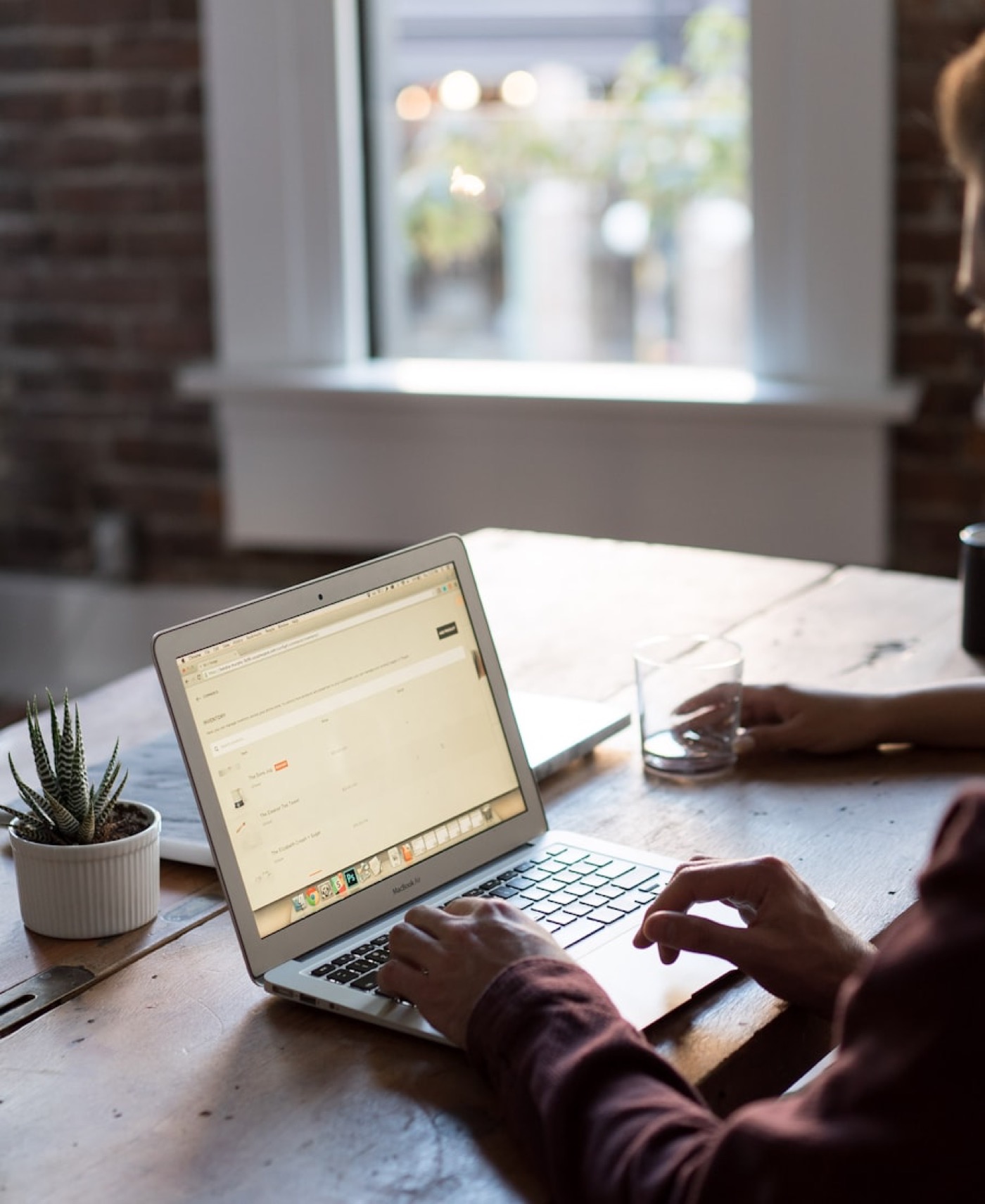 Person working at a laptop in the evening
