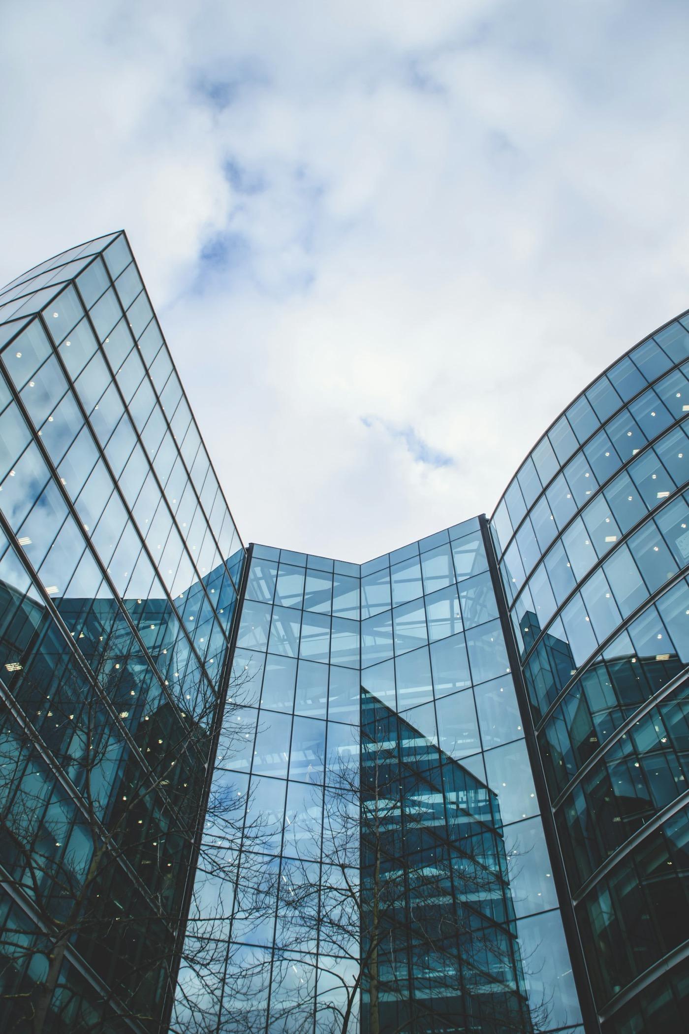 Glass office towers reflecting the sky