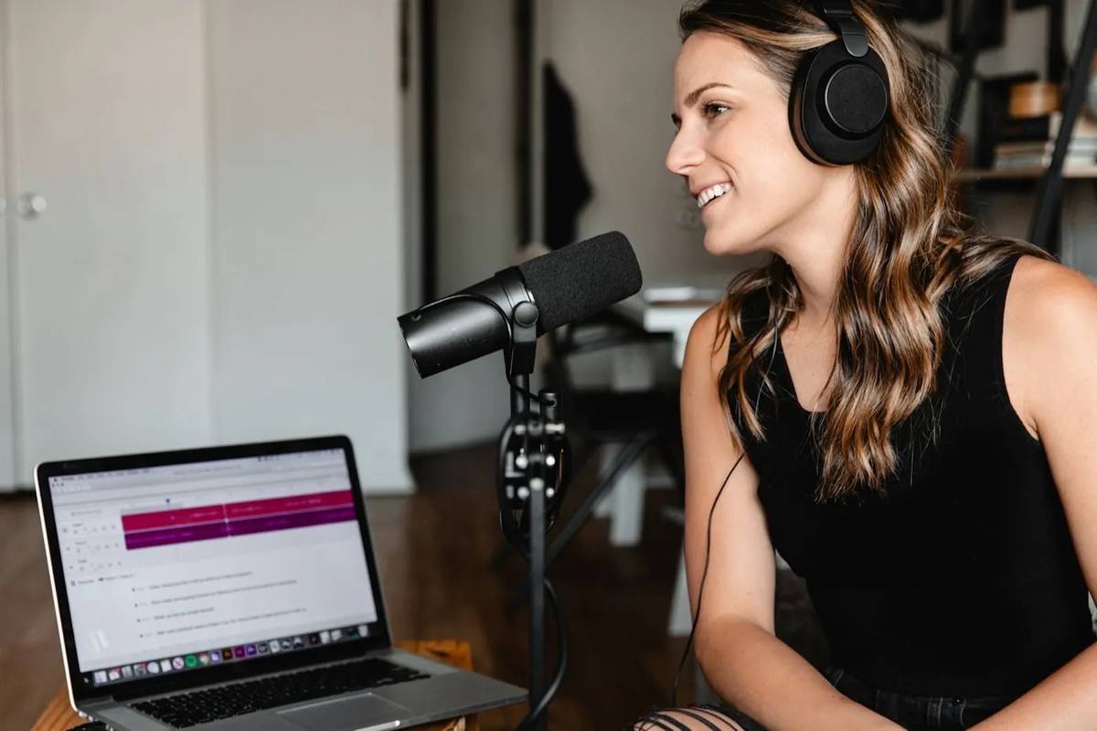 A founder recording content at a desk with a product